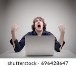 angry man swearing and cursing against information technology and his compuiter worries and hassles - concept of hating computers