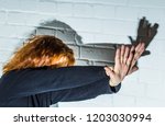 Small photo of Side view of a woman trying to fend off an attack with her arms