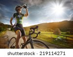 Cyclist is drinking water from the sport bottle 