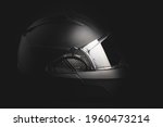 Black modular motorcycle helmet on black background.