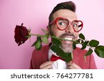 Man holding a rose in mouth 