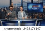 Small photo of Positive anchors talking newscast at modern multimedia channel closeup. Confident man woman newsreaders covering daily news in television studio. Happy newscasters reporting business information