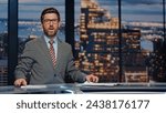 Small photo of Smiling newscaster reporting at newscast modern multimedia channel closeup. Confident newsreader covering daily news in television studio. Bearded anchor man talking business information in air