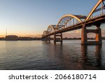 Small photo of A Wide Angle Shot of Beautiful Sunrise Light on the Centennial Bridge Spanning the Mighty Mississippi River Connecting Davenport, Iowa to Rock Island, Illinois