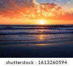 dramatic sunset over the sandy sea beach, dramatic outdoor background