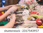 Small photo of Pottery lesson master class for kids children, process of making clay pot on pottery wheel, potter wet hands creating ceramic crockery handcrafts, ceramist molding jar or vase