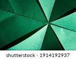 Abstract radial green background of folded textured paper. Close-up image. Concepts: origami, color, lines and geometry.