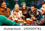 Small photo of Happy friends drinking beer at brewery bar dehor - Friendship lifestyle concept with young milenial people enjoying time together at open air pub - Warm color tones on vivid filter with focus on girls