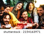 Small photo of Happy friends having fun drinking at house dinner pic nic bbq party - Mixed age range people toasting drinks at fancy restaurant garden together - Staycation life style concept on warm night filter