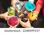 Small photo of Top view of people hands toasting multicolored fancy drinks - Young friends having fun drinking cocktails at happy hour - Social gathering party concept on vivid filter - Shallow depth of field