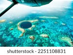 Small photo of Aerial panoramic view of The Great Blue Hole - Detail of Belize coral reef from airplane excursion - Wanderlust and travel concept with nature wonders on azure vivid filter