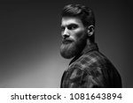 Black and white photo of bearded stylish businessman Handsome confident perfect hairstyle man indoor .