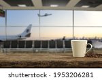 Desk of free space and fresh hot coffee. Airport interior and big window 