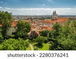 Beautiful Prague old town cityscape seen from the Prague Castle at sunny summer day, Czech Republic. Green and lush garden in Praha stari grad