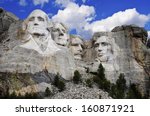 Mt. Rushmore National Memorial Park in South Dakota with bright blue sky in background. Sculptures of former U.S. presidents; George Washington,Thomas Jefferson,Theodore Roosevelt and Abraham Lincoln.