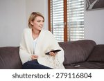 Portrait of young woman watching TV at home sittin on sofa