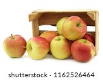 Small photo of fresh Maribelle apples in a wooden crate on a white background