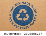 Cardboard Box with Blue Recycle Symbol Background.