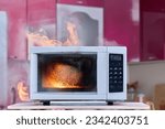 Small photo of Appliance caught fire from overheating or short circuit, microwave oven ignited from inside and resulted in smoke indoors and an open fire.