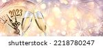 Small photo of 2023 - New Year Celebration With Champagne And Clock - Abstract Defocused Bokeh Lights