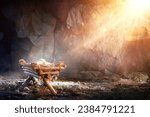 Small photo of Nativity - Waiting Birth Of Jesus Christ With Manger In Cave With Holy Light And Abstract Defocused Bokeh