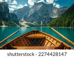 Small photo of Fantastic travel and excursion place in the Dolomites. Great view with mountains and green forest from the wooden rowing boat, lake Braies, Dolomites, Italy, Europe
