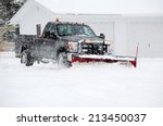 A Worker Plows Heavy White Snow ...