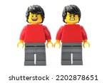 Small photo of Lorrach, BW Germany - September, 12th, 2022: Lego minifigure red torso and black cap smiling and angry. Editorial illustrative image of positive and negative emotions.