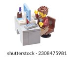 Small photo of Lorrach, Germany - May 25th 2023: Lego minifigure toy of awful pc user with angry face at slow computer isolated on white. Editorial illustrative image of popular plastic brick constructor.