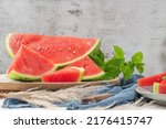 Small photo of Composition of ripe watermelon and fresh mint on the kitchen table. Ripe summer watermelon. Juicy watermelon. Concept of seasonal fruits on the table