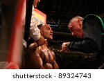 Small photo of FLORENCE, ITALY - NOV 4: "Leonard Bundu" [Boxer] at his corner attended by an assistant at "European Welter Boxing Title" in Florence, Italy on Nov 4, 2011.
