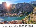 Small photo of Beautiful sunny cityscape, town of Omis on the banks of Cetina river, canyon and rocky Dinara mountains, top view from Mirabella (Peovica) fortress, mediterranean tourist resort in Dalmatia, Croatia