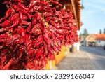 Famous Hungarian dried red pepper or paprika in souvenir shop on a cozy street of the Tihany village in summer time, outdoor travel background, Veszprem region, Hungary
