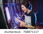 Happy woman playing slot machines in the casino