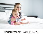 Baby And His Brother On Bed