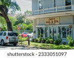 Small photo of NEW ORLEANS, LA, USA - JULY 15, 2023: Front of Cindy's Nail and Spa and a vehicle illegally parked at a fire hydrant and in a bus stop on South Carrollton Avenue