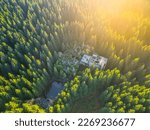 Ruins of former tin mine near Rolava village in the forests of Ore Mountains, Czech Republic. Aerial view from drone.