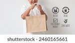 Cute asian boy holding jute bag ...