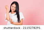 Small photo of Portrait of Asian beautiful young woman applying lotion cosmetic moisturizer cream on her elbow skin, studio shot isolated on pink background, Healthcare medical and hygiene skin body care concept