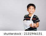 Small photo of Arm broken. Little cute kid boy 5-6 years old hand bone broken from accident with arm splint in studio shot isolated white background, Asian children preschool injured after accident, health concept