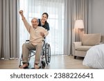 Small photo of Happy curator person doctor pushing wheelchair and run elderly disabled patient freedom raising arm at hospital, senior retired man sitting on wheelchair having fun with young woman nurse, health care