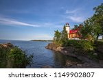 Lighthouse On A Rocky Coast. The Eagle Harbor Lighthouse on the rocky shore of Lake Superior. Eagle Harbor, Upper Peninsula, Michigan, USA.