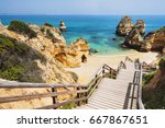 Wooden footbridge to beautiful beach Praia do Camilo near Lagos in Algarve region, Portugal