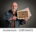 Small photo of consistent, compelling content - recommendation for creativity, blogging and social media marketing - word abstract in vintage letterpress wood type on a paper sheet held by a senior man