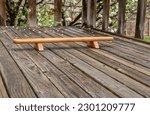 Small photo of Persian shena push up board on a backyard wooden deck in springtime scenery