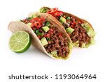 Mexican tacos with beef, tomatoes, avocado, chilli and onions isolated on white background. With clipping path.