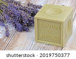 Marseille soap with written on it in French "Marseille soap" and lavender bouquet