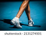 Small photo of MELBOURNE, AUSTRALIA - JANUARY 24, 2022: Closeup of footwork and legs of an active tennis player on a hot summer's day in Melbourne, Australia