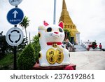Small photo of Animal fetish and figurine maneki neko cat amulets statue in garden park for thai people traveler travel visit and blessing wish holy at Wat Khao Din Temple on October 7, 2023 in Suphan Buri, Thailand