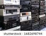 Small photo of WROCLAW, POLAND - JANUARY, 2020. Wall of Retro Audio Devices for Sale on a Flea Market. Stereo Amplifiers, Compact Disc Players, Receivers, Video Cassette recorder, Stereo Cassette Deck
